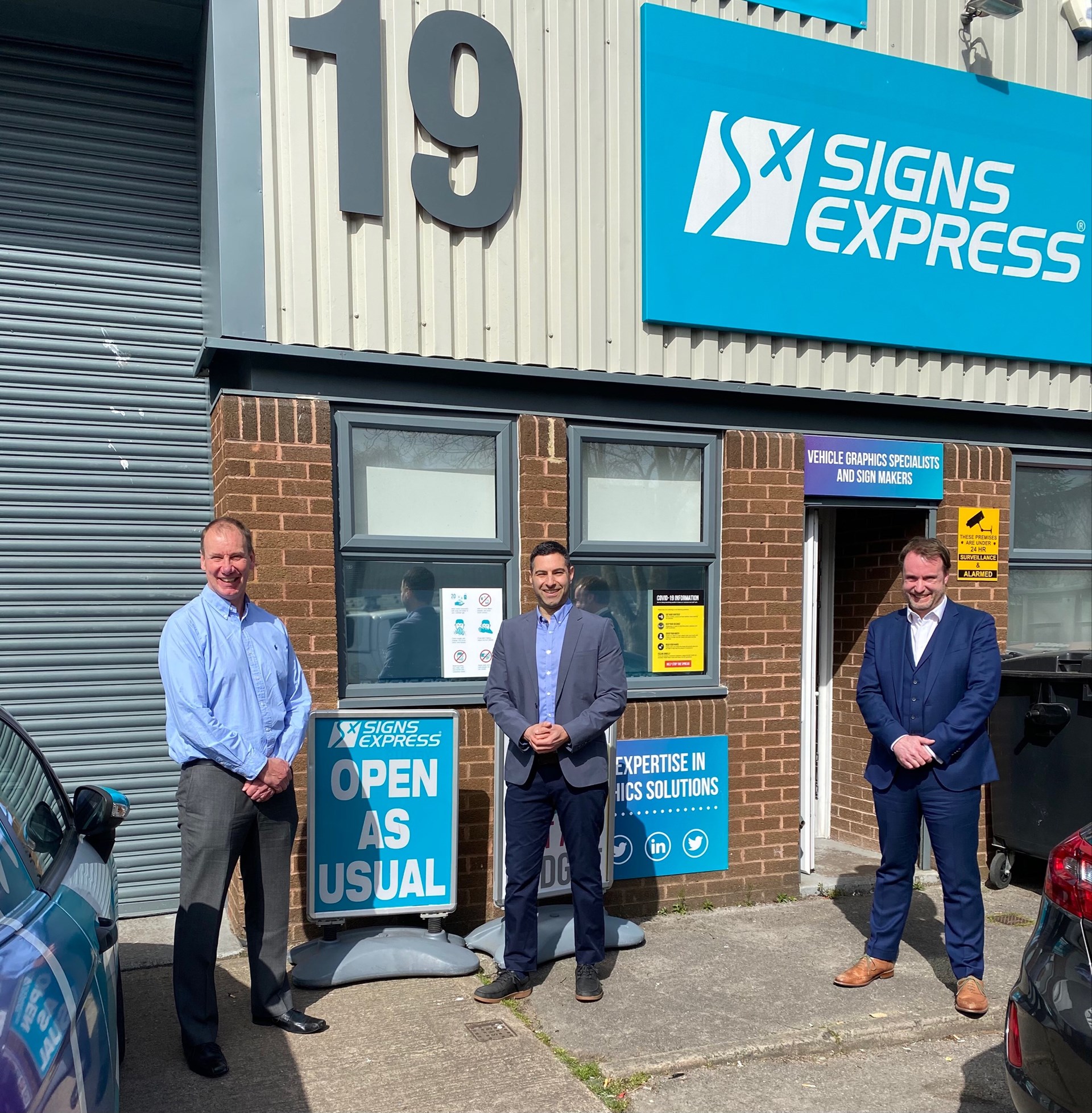 From Left To Right Darryl Lillie, Previous Owner Of Signs Express (Gloucester), Ben Walker New Owner Of Signs Express Gloucester) And Jonathan Bean Managing Director Of Signs Express Limited