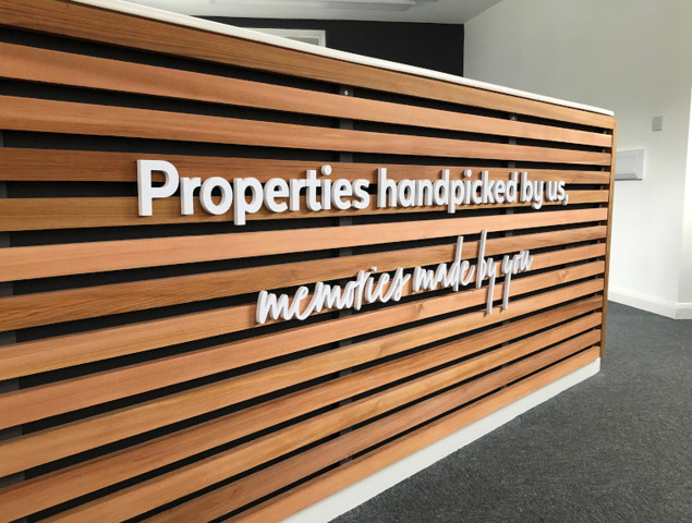 Internal 10mm lettering on a bespoke wooded reception counter.