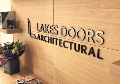 Reception wall logo made from satin black acrylic with bronze vinyl