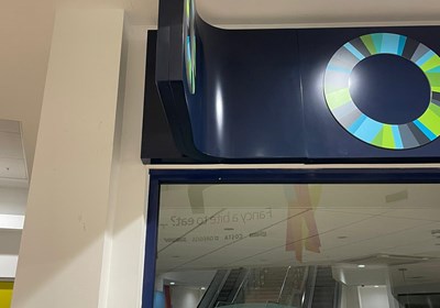 LED illuminated projecting sign with unique integration into fascia panel