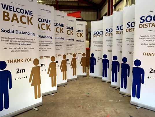 Portable Roll Up Banners With Social Distancing Message For Helston Garages