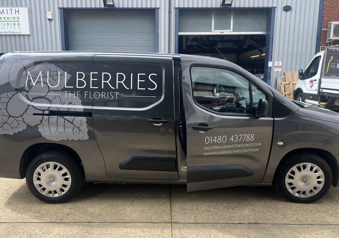 White vinyl text and printed leaf watermark for Mulberries The Florist