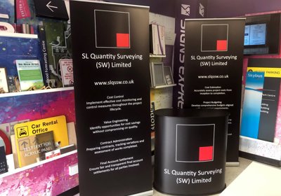 Freestanding Display Counter With Shaped Top & Budget Roll Up Banner Stands