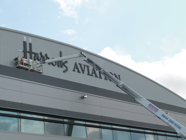 Installation In Progress Of 'H' In Harrods Aviation Logo By Signs Express Harlow Install Team